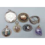 A Victorian mourning brooch together with two silver brooches and four pendants