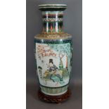 A 19th Century Chinese vase decorated with figures amongst foliage with polychrome enamels