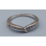 An 18ct white gold ring set with diamonds, ring size I, 2.2gms, one stone missing