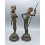 Emile Guillemin, a pair of patinated metal candlesticks, of stylised figural form, 31cms tall