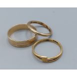 An 18ct gold band ring, 1.3gms, together with a 9ct gold wedding band, 1.8gms and an unmarked band