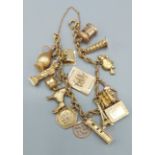 A 9ct gold charm bracelet with many charms, 32.5gms