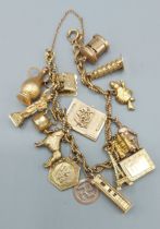 A 9ct gold charm bracelet with many charms, 32.5gms