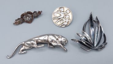 A silver brooch in the form of a Jaguar together with three silver brooches
