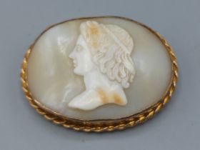 A 9ct gold framed oval cameo brooch relief decorated with a bust, 5cms by 3.5cm