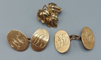 A pair of 9ct gold cufflinks together with a 9ct gold brooch of leaf form, 11.6gms