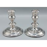 A pair of London silver dwarf candlesticks with circular bases, 11cms tall