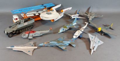 A Dinky Toys USS Enterprise together with other model vehicles and model aeroplanes