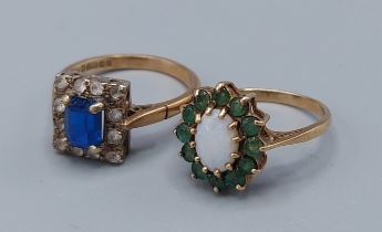 A 9ct gold dress ring set with a central Opal surrounded by emeralds together with another 9ct