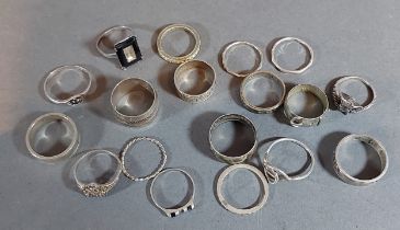 A collection of eighteen silver dress rings