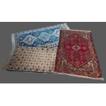 A Northwest Persian woollen small rug, 127cms x 74cms together with two other small rugs