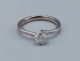 An 18ct gold solitaire diamond ring with crossover claw setting, approximately 0.35ct, ring size