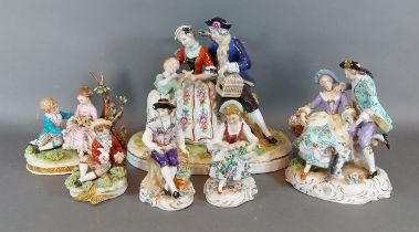 A German porcelain group together with a pair of German porcelain figures and three other similar