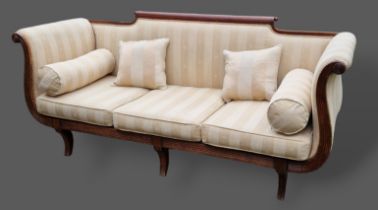 A William IV mahogany scroll end sofa with reeded arms and raised upon sabre front legs, 202cms long
