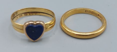 A 22ct gold band ring set with a blue stone in the form of a heart together with a 22ct gold wedding