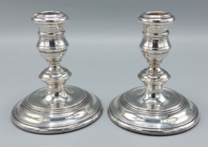 A pair of London silver dwarf candlesticks with circular bases, 11cms tall