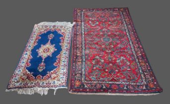 A Northwest Persian woollen rug with an all-over design upon a red, blue and cream ground within