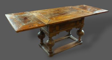 A late 18th or early 19th Century oak refectory style drawer leaf dining table with turned bulbous