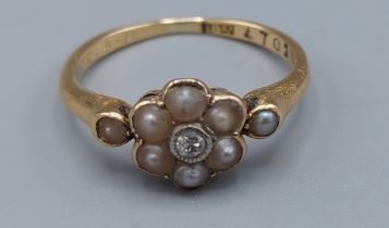 An 18ct gold ring set with a central diamond surrounded by pearls, 2.5gms, ring size J