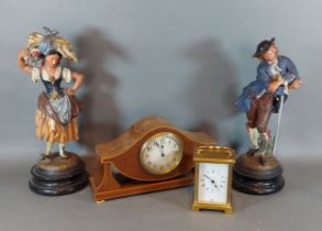 A pair of painted metal figures together with an Edwardian mantle clock and a brass cased carriage