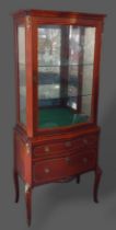 A French kingwood Vitrine with a glazed door enclosing glass shelves, the lower section with two
