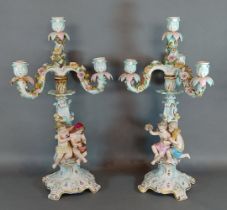 A pair of Meissen porcelain candelabrum, each mounted with Putti decorated in polychrome enamels and