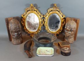 A pair of oval gilded wall mirrors of pierced form, 30cms x 19cms together with a pair of bookends