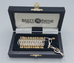 Brett Payne, a silver and gold mounted necklace of linked form withing fitted box, 95.8gms, 52cms