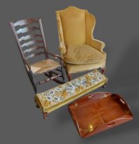 A wingback armchair together with a fender stool, an oak rocking chair and a butlers tray