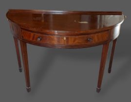 An Edwardian mahogany and line inlaid demi-lune side table by Maple and Co. with a frieze drawer