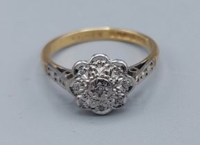 An 18ct gold Diamond set cluster ring, ring size M, 3.1gms