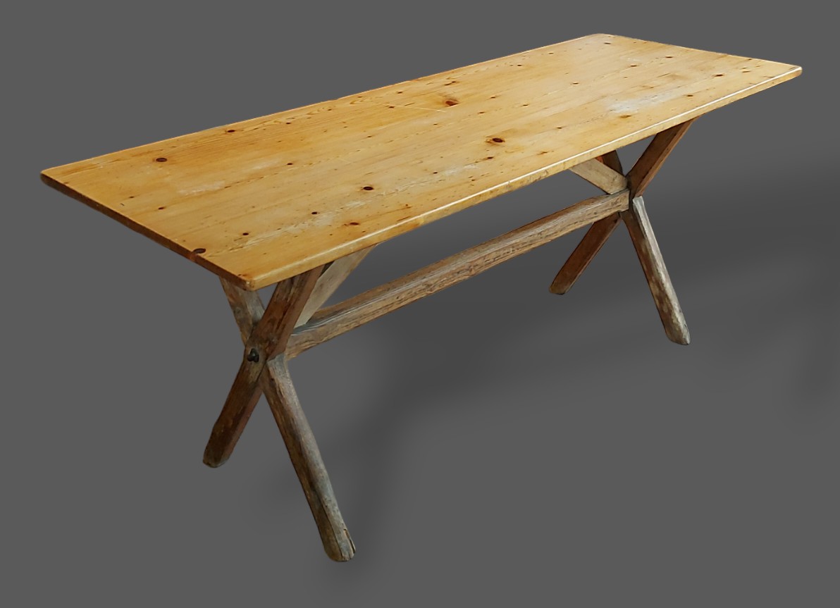 A pine refectory style dining table with crossover supports, 179cms x 66cms