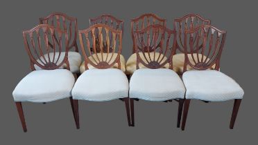 A set of eight 19th Century mahogany dining chairs with shaped backs above stuff-over seats raised