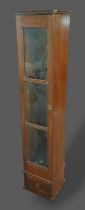 A 20th Century oak gun cabinet with a glazed door above a drawer, 29cms wide, 26cms deep and