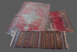 A Northwest Persian woollen rug together with two similar rugs