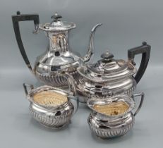 A Sheffield silver four piece tea service comprising teapot, hot water pot, cream jug and sucrier