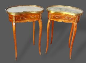 A pair of French kidney shaped side tables the brass galleried and marble tops above a frieze drawer