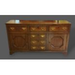 A 19th Century oak dresser base with three drawers above thre central simulated drawers flanked by