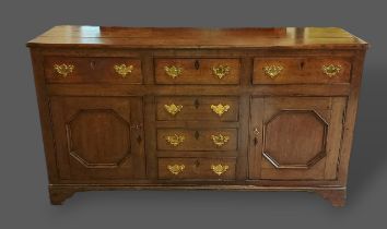 A 19th Century oak dresser base with three drawers above thre central simulated drawers flanked by
