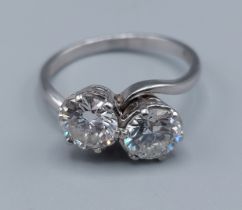 A Platinum two stone crossover diamond ring, the diamonds approx. 1.00ct/0.93ct, colour H-I