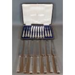 A set of six dessert knives and forks with silver handles within fitted case together with a set