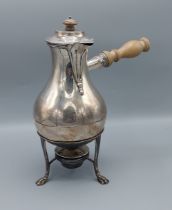 A Edwardian silver coffee pot of bulbous form with turned wooden handle, upon stand with paw feet