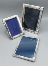A London silver rectangular photograph frame, 22cms x17cms together with two similar silver