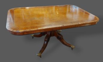 A Regency mahogany large centre table of rectangular form with turned centre column and out swept