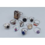 A collection of eleven silver dress rings set various stones