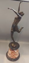 A patinated bronze in the form of an Art Deco dancing girl with marble socle, 64cms tall