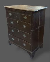 A George III oak chest, the moulded top above three short and three long drawers raised upon bracket
