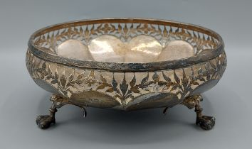 A George V silver circular fruit bowl, with pierced foliate decorated rim, raised upon three