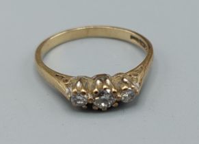 A 9ct gold three stone diamond ring, ring size L, 1.7gms