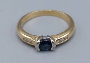 An 18ct gold solitaire Sapphire ring with Diamond shoulders, ring size P, 4gms